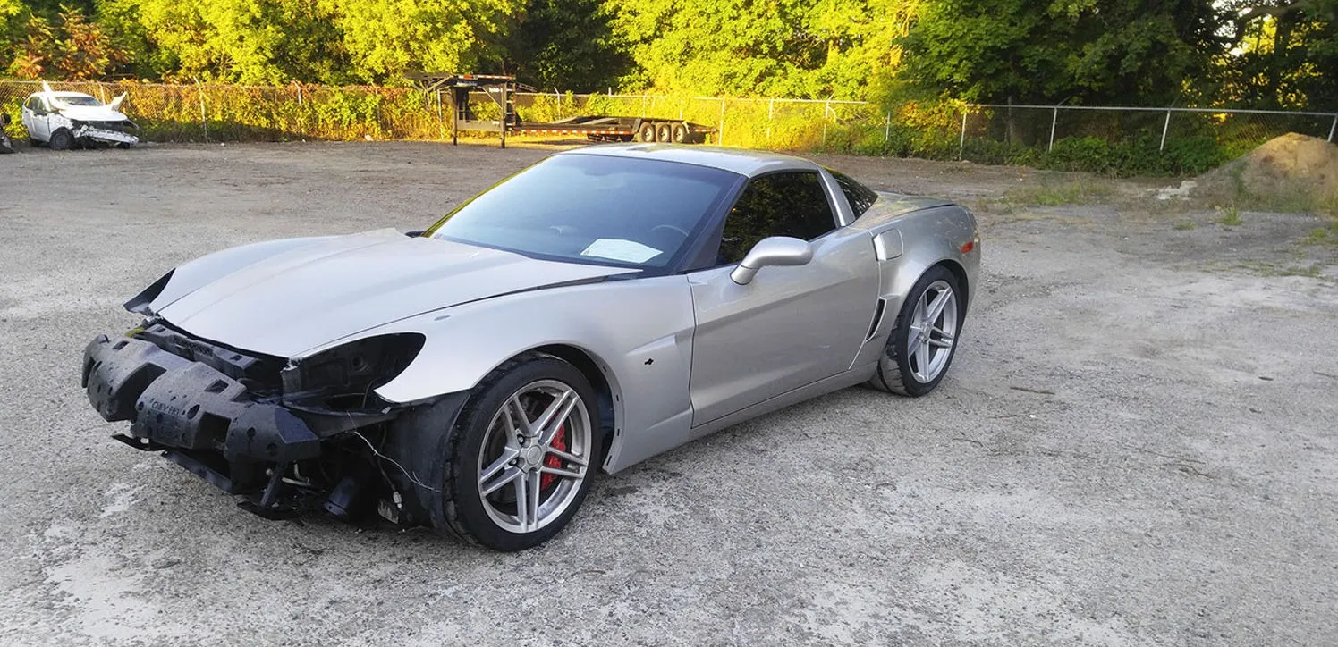 Silver Corvette with the front end torn off, before structural repair