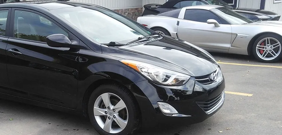 Black Hyundai Elantra after panel repair and refinishing at Spanky's