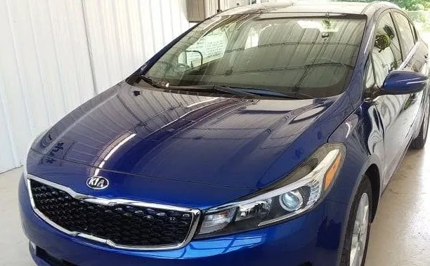 Refinished blue Kia Forte after paint work at Spanky's